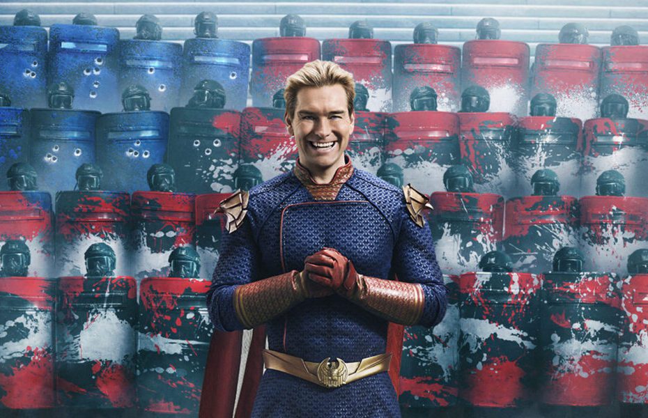 Homem de uniforme de super-herói sorrindo em frente a escudos coloridos.